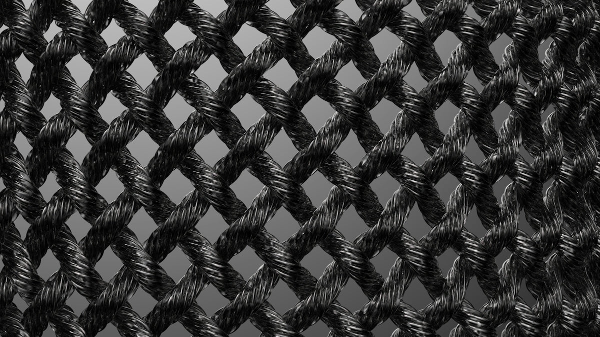 a black and white photo of a wire fence