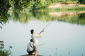 a man and a boy fishing on a dock