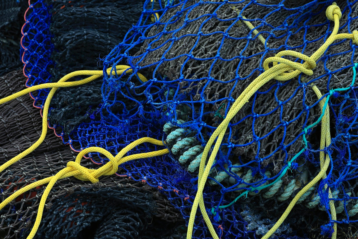a pile of blue and yellow fishing nets