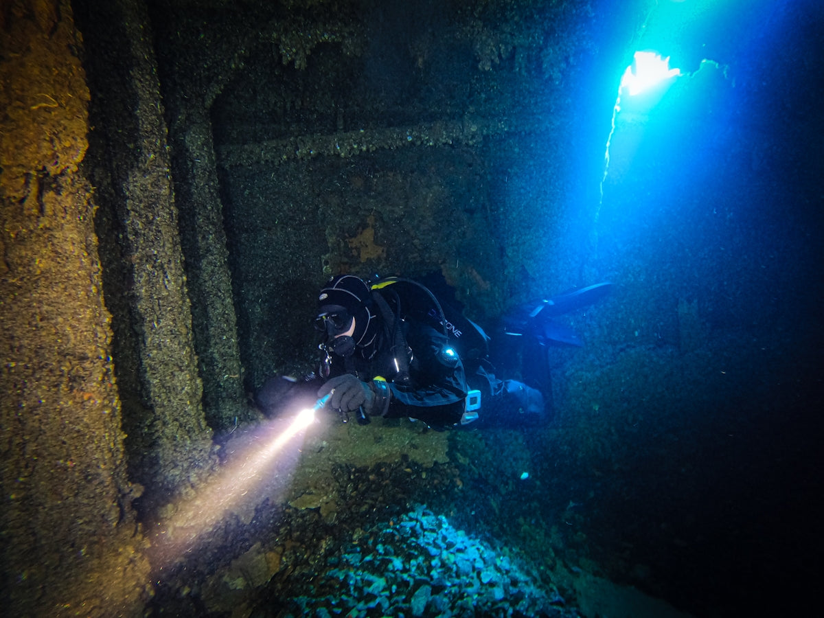 Adventure A Guide to the XTAR D26 2500 Diving Flashlight showcasing a diver exploring underwater ruins.