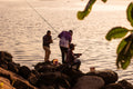 A group of people standing on top of a rocky shore
