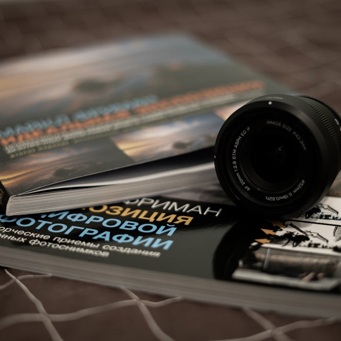 Books about photography with a camera lens.
