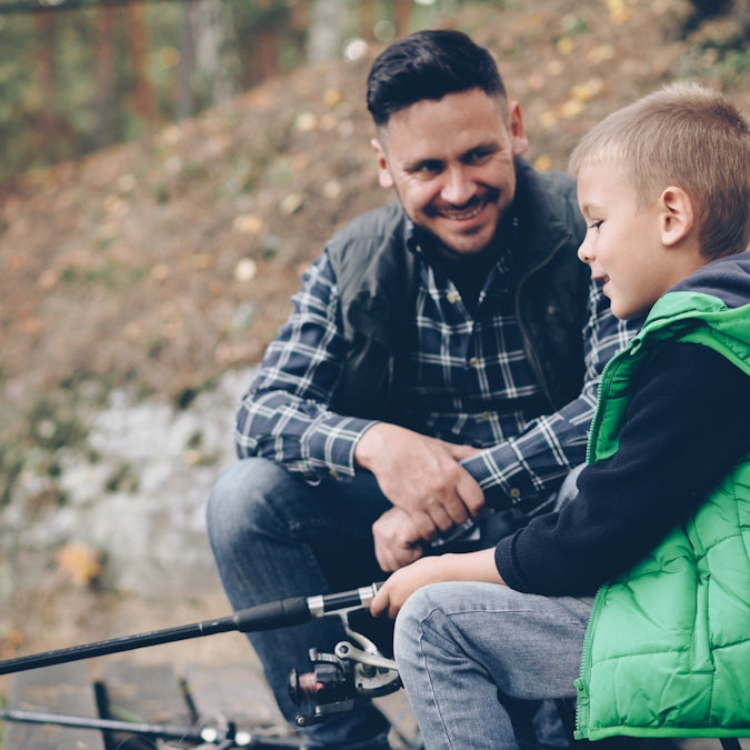 Father and son are enjoying a fishing trip.