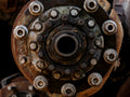 Close-up of a rusty, weathered wheel hub assembly