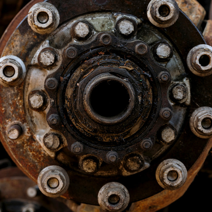Close-up of a rusty, weathered wheel hub assembly