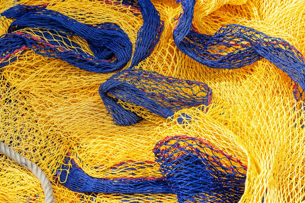 4mm Braided Lead Core Rope used in fishing nets and curtains, featuring vibrant yellow and blue colors.