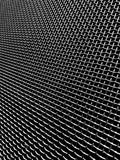 Close-up of a metal mesh screen with a dark background