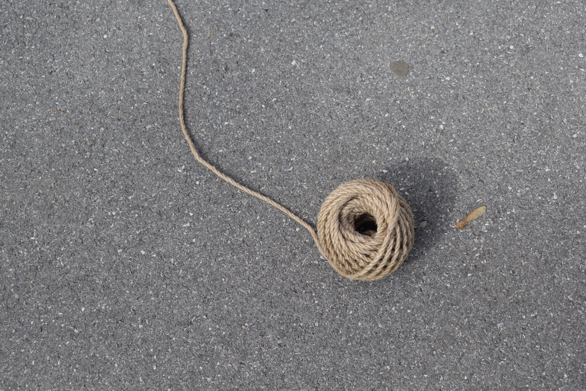 A ball of twine on a gray surface