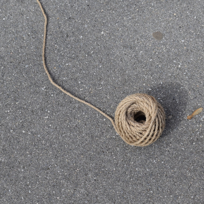 A ball of twine on a gray surface