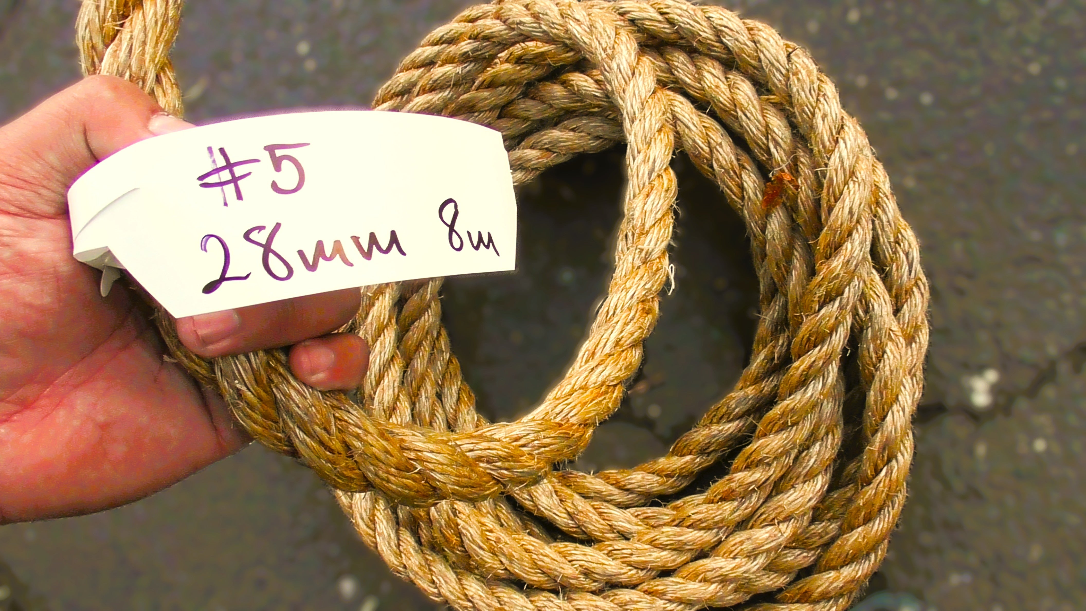 Special Manila Rope Shorts 28mm - 8m coiled rope in hand with label showing size and length.