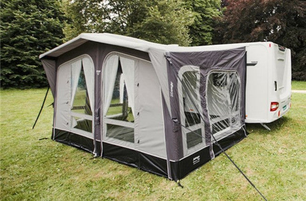 Vango Riviera 390 Awning Elements Pro Shield set up outside a caravan in a grassy area.