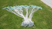 20M to 100m Herring Bait Fishing Nets 2.5 inch laid out on grass, showcasing mesh and design.