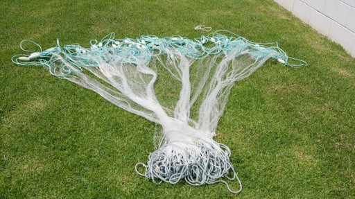20M to 100m Herring Bait Fishing Nets 2.5 inch laid out on grass, showcasing mesh and design.