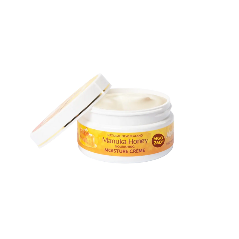 Alpine Silk Manuka Honey Moisture Cream 100g in an open jar showcasing the creamy texture inside.