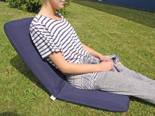 Comfort Sundeck Seat in use outdoors, showcasing flexible seating on grass, providing superior comfort.