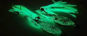 Boss Squid glowing jigs featuring detailed paintwork and vibrant colors for effective fishing.