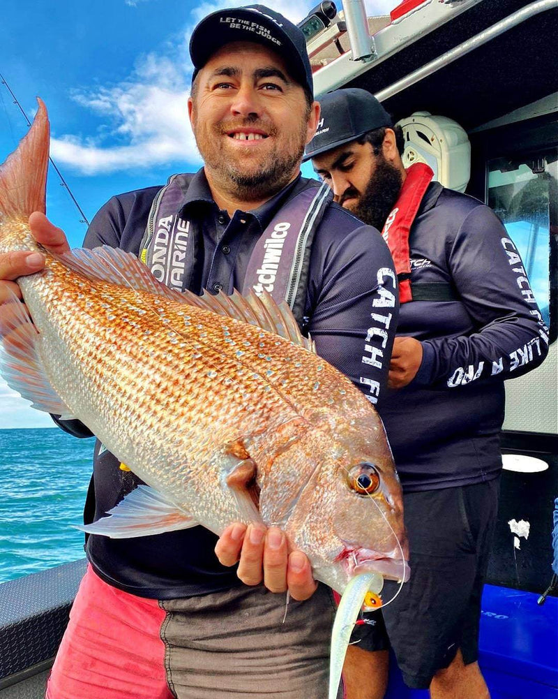 Catch Black Label Livies pk 4x7" White Warrior used in fishing catch with a fisherman holding a large snapper.