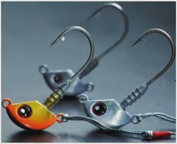 1/4 ozTenya Jig Head  Stingaz Glow +UV fishing jig heads featuring vibrant colors and sharp hooks.