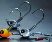 Catch Stingaz Tenya Jig Heads with Gripper 28g displayed on a dark background, showcasing their innovative design.