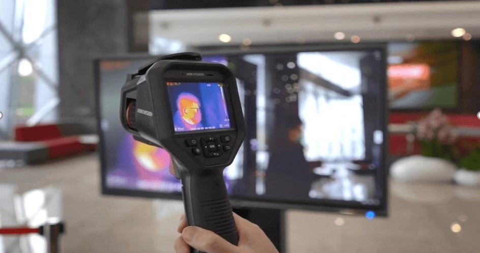 Temperature Screening Thermo Handheld Camera in use, displaying thermal imaging on an LCD screen.