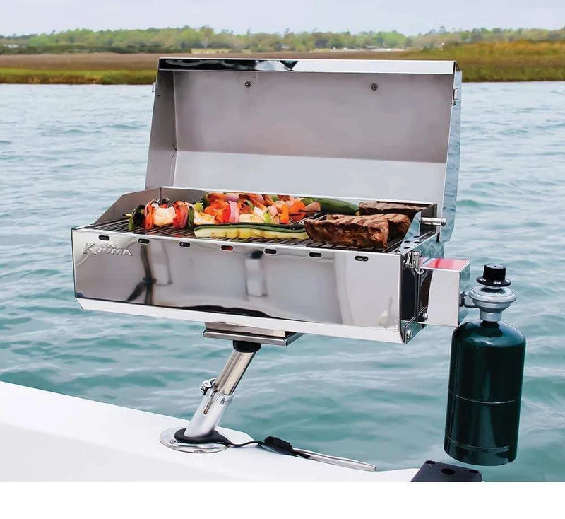 Stow and Go Barbecue Coleman Canister type grilling steak and vegetables on a boat.
