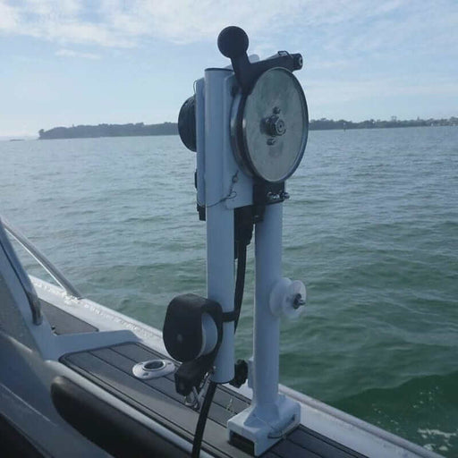 Maxtek Cray Pot Hauler 12V 90kg Lift mounted on a boat in a scenic water view, showcasing its marine-grade design.