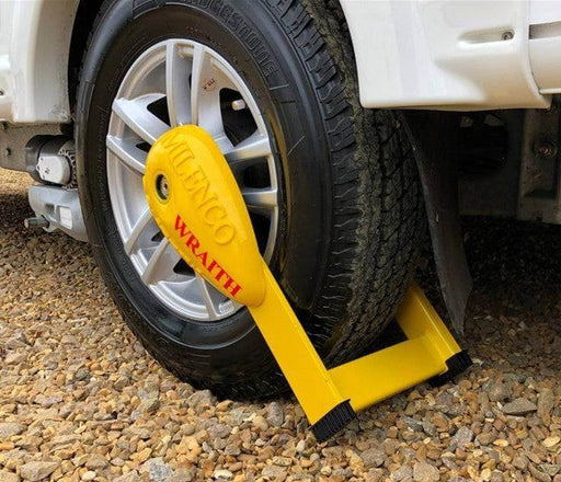 Milenco Wraith 2 Motorhome Wheel Lock securely fitted on a tire, showcasing its vibrant yellow color and sturdy design.