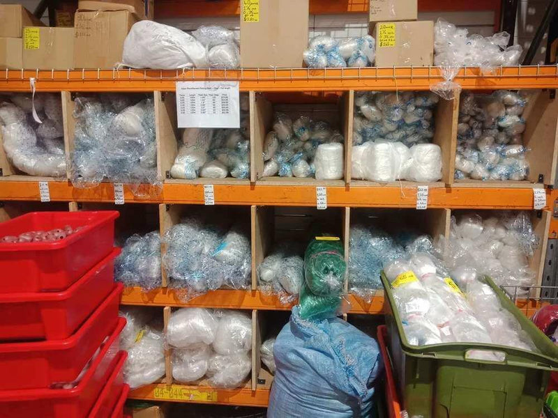 Unslung Mono 0.35mm 2-1/2 inch x 50md x 200 yds displayed on a storage shelf in a warehouse.