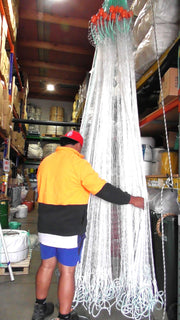 Mullet and Snapper Nets Multi Purpose with Multi Mono Mesh hanging in storage with a person holding one.