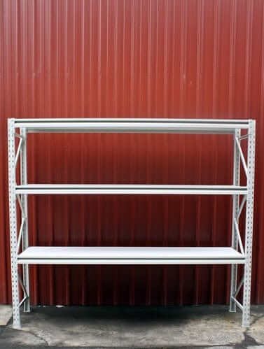 New Longspan  Racking/Shelving 2100x1500x450-3Level with three shelves against a red metal wall.