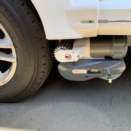 Powrtouch Twin Axle Caravan Mover (4 Motor Auto) installed on a caravan tire showcasing its compact design and functionality.