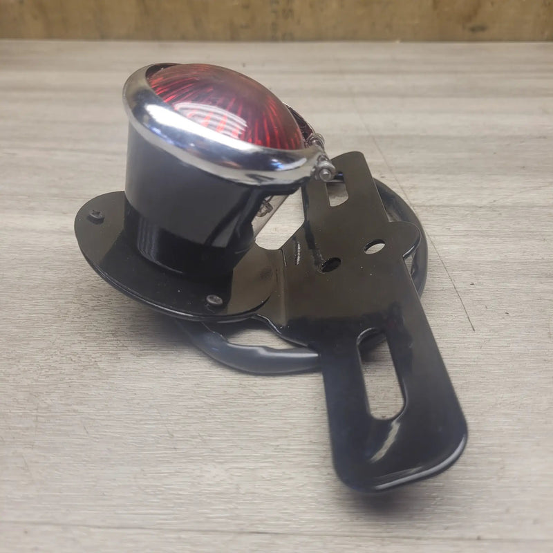 Aftermarket rear brake light/number plate bracket by Motor Morgue