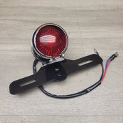 Aftermarket rear brake light/number plate bracket by Motor Morgue