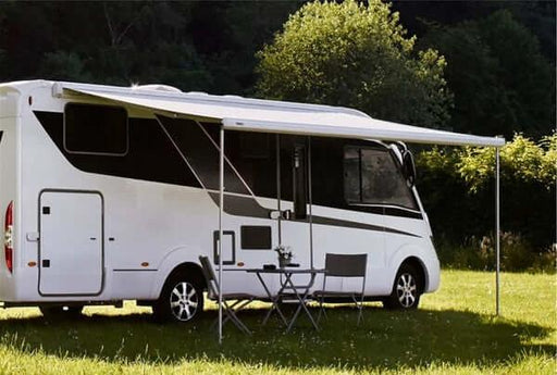 Thule 5200 Awning Sapphire Blue - 4.5m installed on a stylish RV in a lush green outdoor setting.