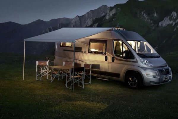 9200 Thule Awning Mystic Grey 5.5m / White case installed on a camper van in a scenic outdoor setting.