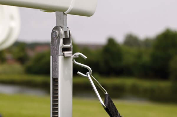 Thule awning hold down straps attached to support leg, ensuring stability and protection for the awning.