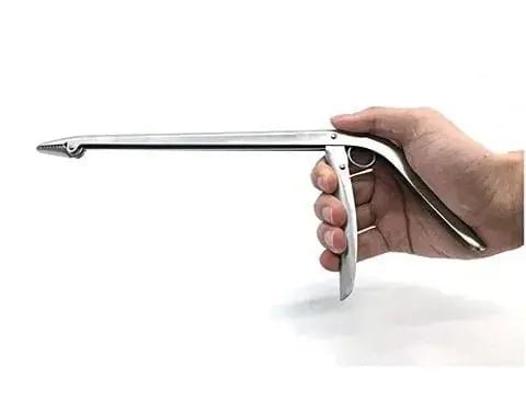 Sea Harvester Fish Hook Remover Stainless being held in a hand for effective fish hook removal.