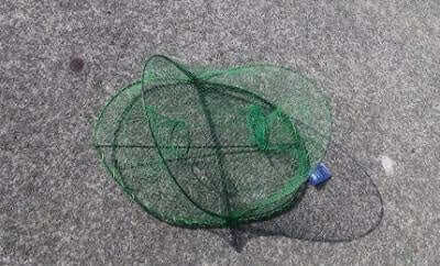 Crab Opera House Pot on a flat surface, showcasing its collapsible net design for easy use.