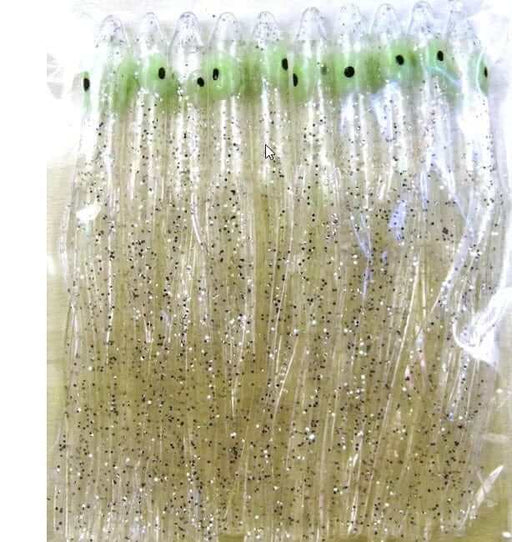 Needle Fish Clear 90 MM PKT10 fishing skirts in clear and green with black spots, enhanced for attracting fish.