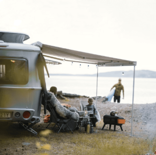 Bracket-Ducato/Jumper/Boxer Series 6 PRE 2007 roof-mounted awning setup at a scenic campsite.