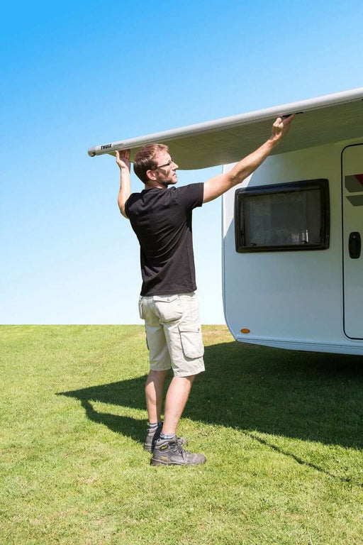 Thule 1200 Caravan Bag Awning - 2.60m installation with a man extending the awning outdoors.