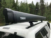 Thule 6300 Anthracite Roof Mount Awning Mystic Grey - 3.50m mounted on a vehicle roof in the rain.