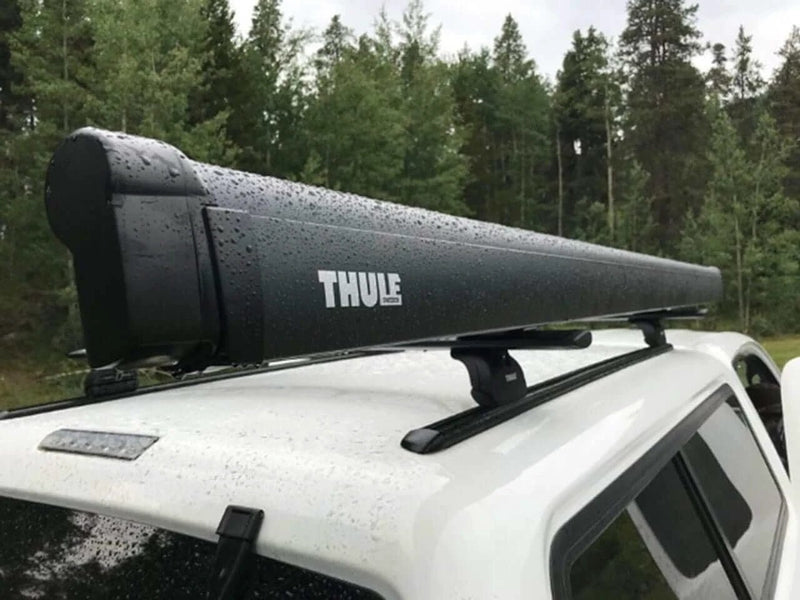 Thule 6300 Anthracite Roof Mount Awning Mystic Grey - 3.50m mounted on a vehicle roof in the rain.