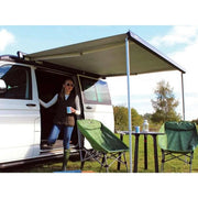 Thule 6300 Anthracite Roof Mount Awning Mystic Grey - 3.75m providing shade for outdoor seating.