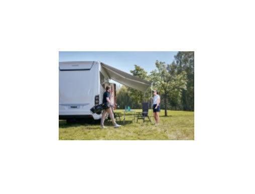 9200 Thule Awning Mystic Grey 5.5m / White case installed on camper with people enjoying outside.