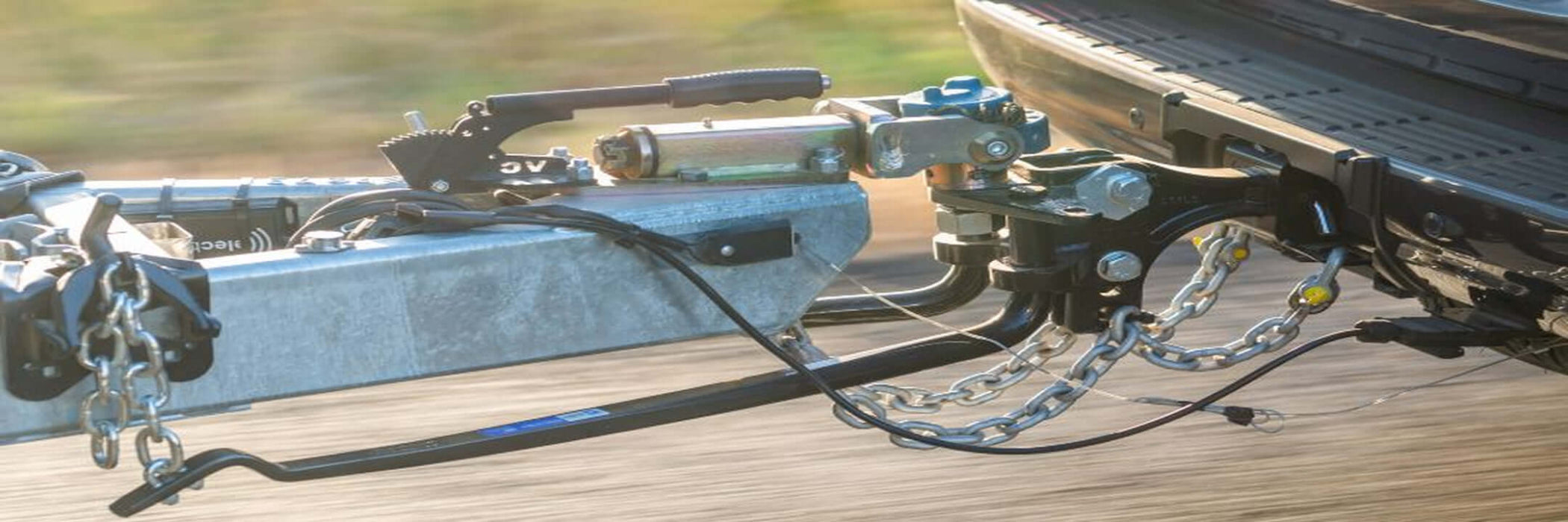Towing hitch with chains on a trailer bed