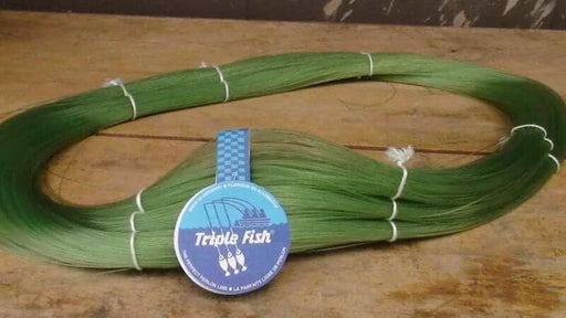 TripleFish Nylon 25kg 30kg 32kg 35kg 40kg 1000m fishing line in green color on a wooden surface.