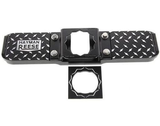 Hayman reese hitch step in black powder-coated aluminum with non-slip platform for easy vehicle access.