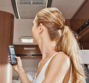 Truma Aventa Comfort 240V Roof Top Aircon - Silver/White remote control adjustment in a vehicle interior