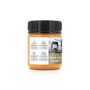 UMF 24+ Raw Multifloral Manuka Honey 225g in a jar with label detail and black lid.